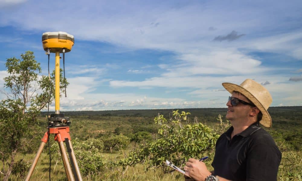 Surveyor using GPS equipment during construction staking surveys to verify site layout accuracy