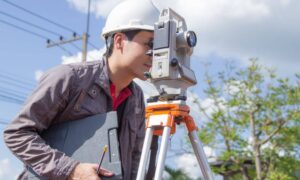 Land surveyor field verification work - ALTA SURVEY Indiana Land surveyor conducting field verification as part of a topographic survey