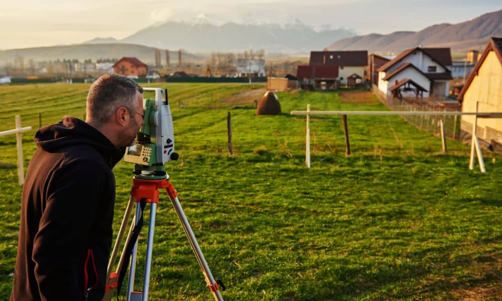 Professional land surveying in progress to measure residential property boundaries