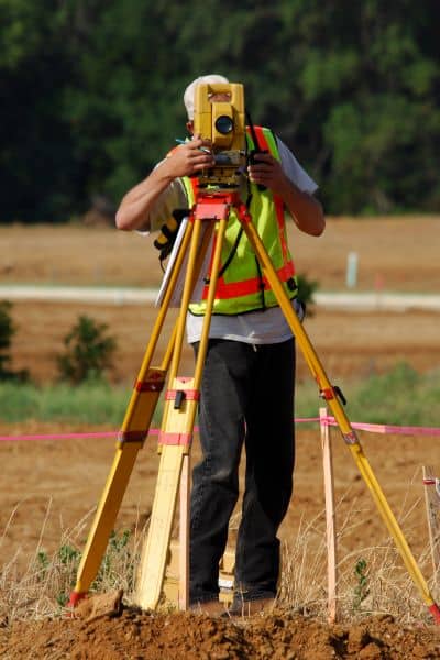 mortgage survey property line check - ALTA SURVEY Indiana Surveyor using a total station to conduct a mortgage survey and check property lines for encroachments, easements, and restrictions