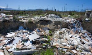 Illegal dumping on vacant land - ALTA SURVEY Indiana Construction debris dumped on an unmarked lot, showing why a boundary survey is needed to protect a property