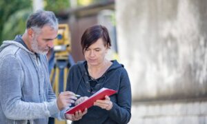 Land surveyor explaining a property access request to a homeowner on site