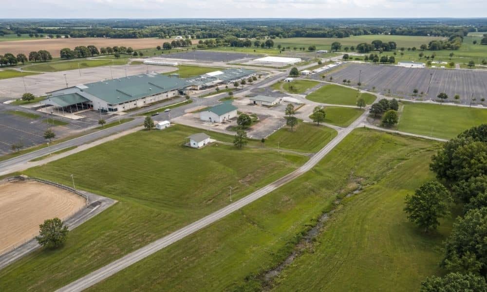 Aerial view of county fairgrounds in showing buildings, parking areas, open land, and grade changes for a topographic survey